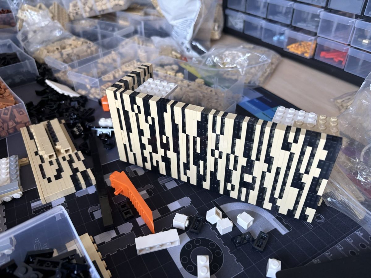 First facade panel: the tan-and-black pattern laid out piece by piece.