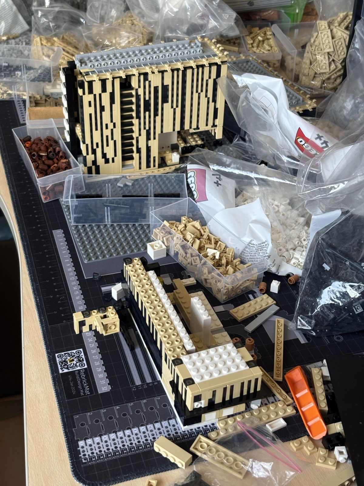 The first tower stands; the low block starts at its foot.